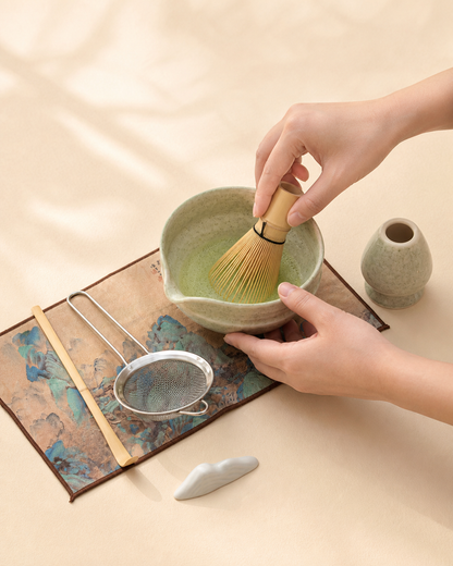 Whisking matcha in the Bamboo Whisper bowl, whisk holder and sifter beside it