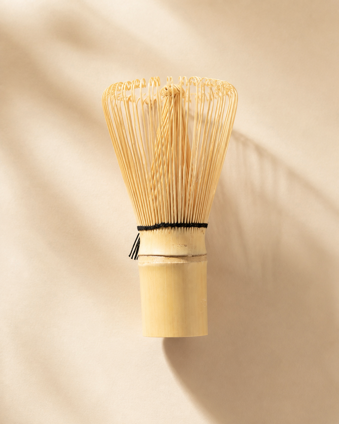 Bamboo whisk, scoop, and tea spoon arranged for a daily matcha ritual