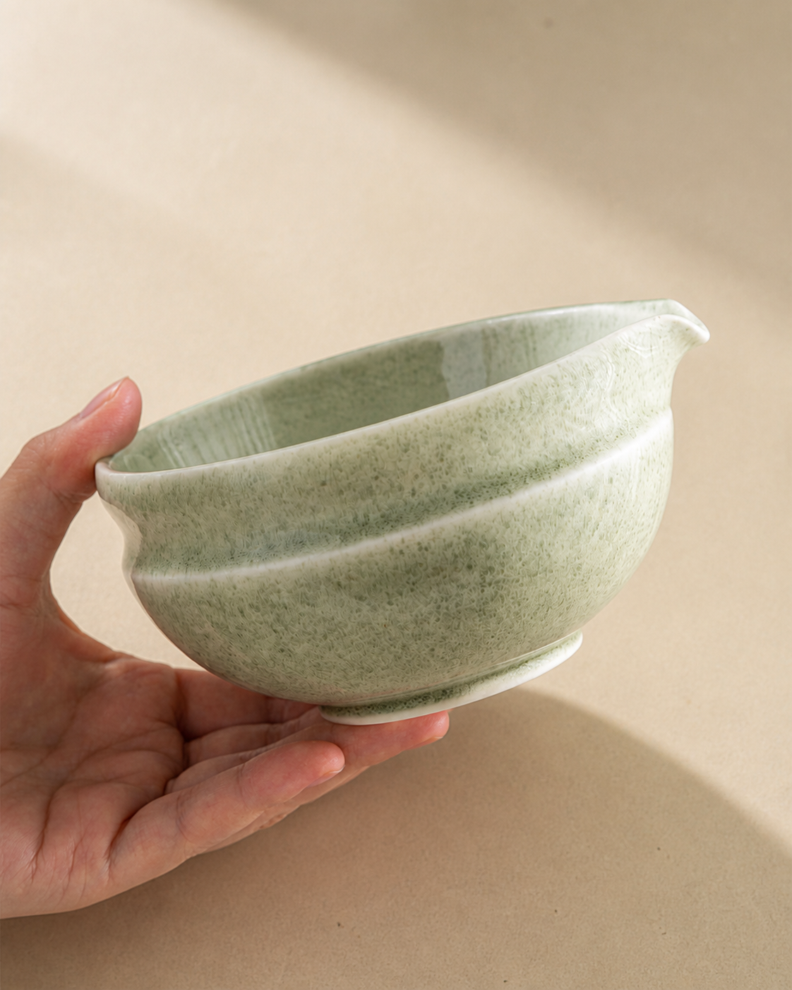Holding the empty Bamboo Whisper ceramic matcha bowl, showing texture and glaze