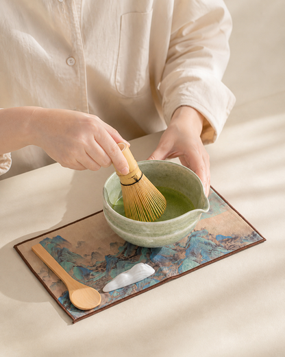 Whisking matcha in the Bamboo Whisper bowl on the tea mat with scoop and utensil rest