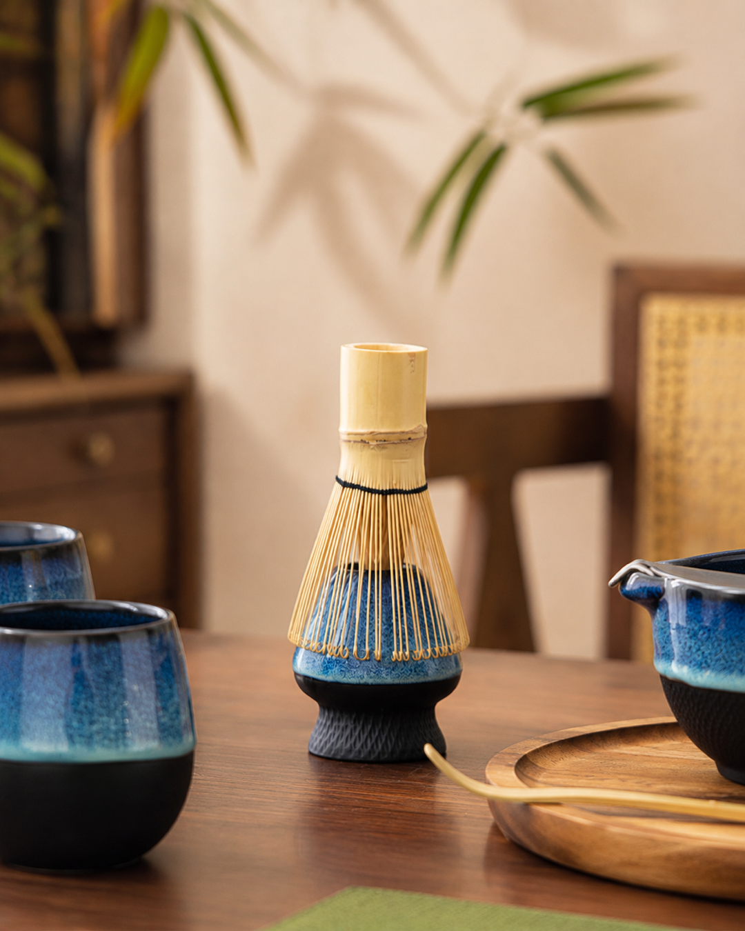Bamboo whisk on holder with blue ceramic Kiln & Ritual matcha pieces
