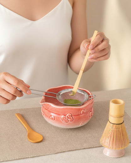 Sifting matcha powder into the Sakura Pink ceramic bowl